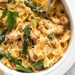 chicken asparagus pasta bake sprinkled with parmesan close up.