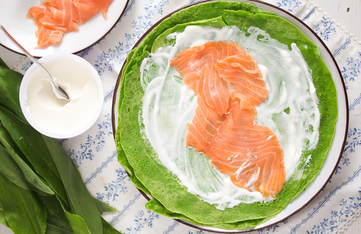 filling crepes with creme fraiche and salmon slices