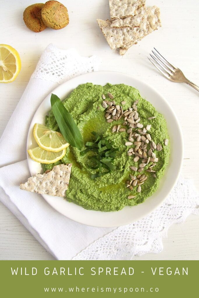 plate with green vegan dip with sunflower seeds and wild garlic