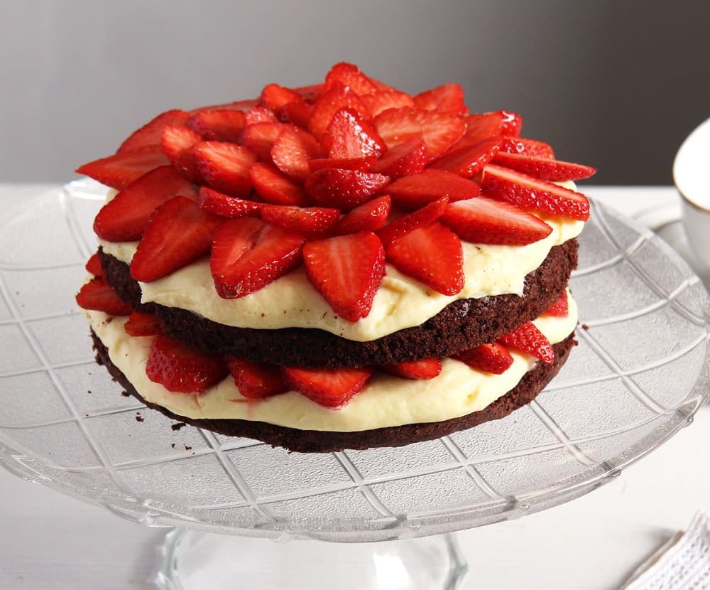 chocolate cake with condensed milk filling on a tall platter.