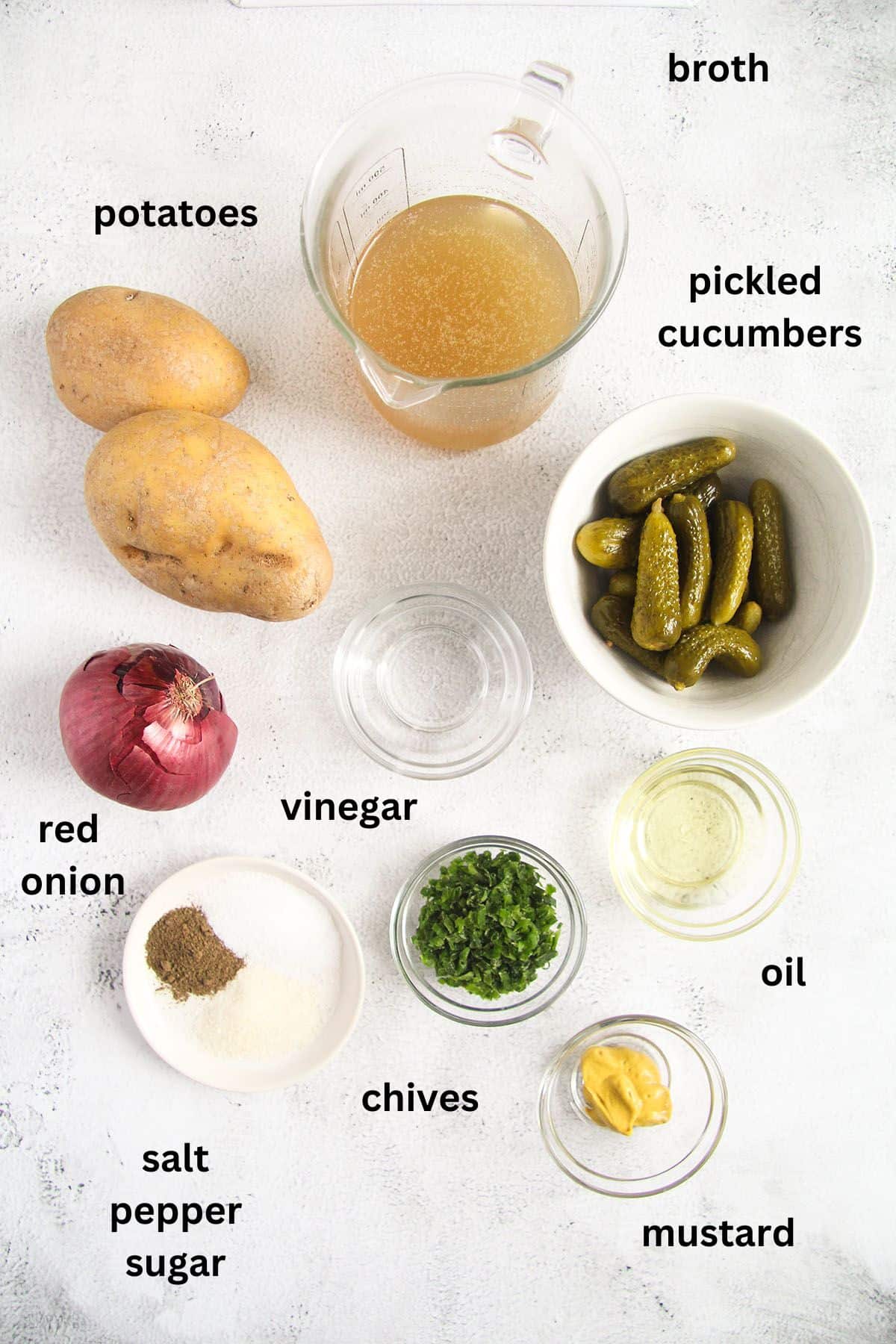 listed ingredients for making german potato salad with oil, vinegar and onions.