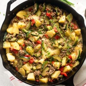 ground beef zucchini and potato skillet sprinkled with lots of herbs.