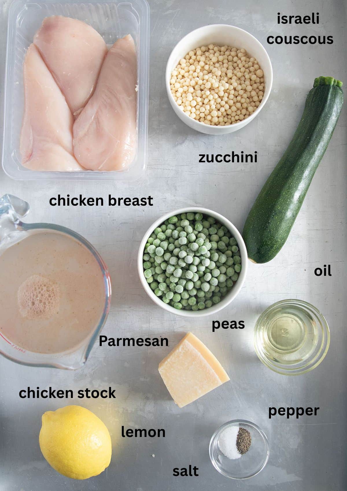 labeled ingredients for making israeli couscous with chicken, zucchini, peas, broth, parmesan and lemon.