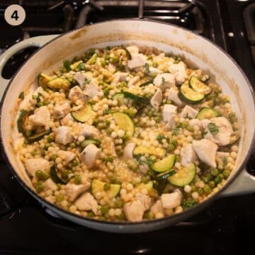 cooking chicken breast pieces and couscous in a large pot.