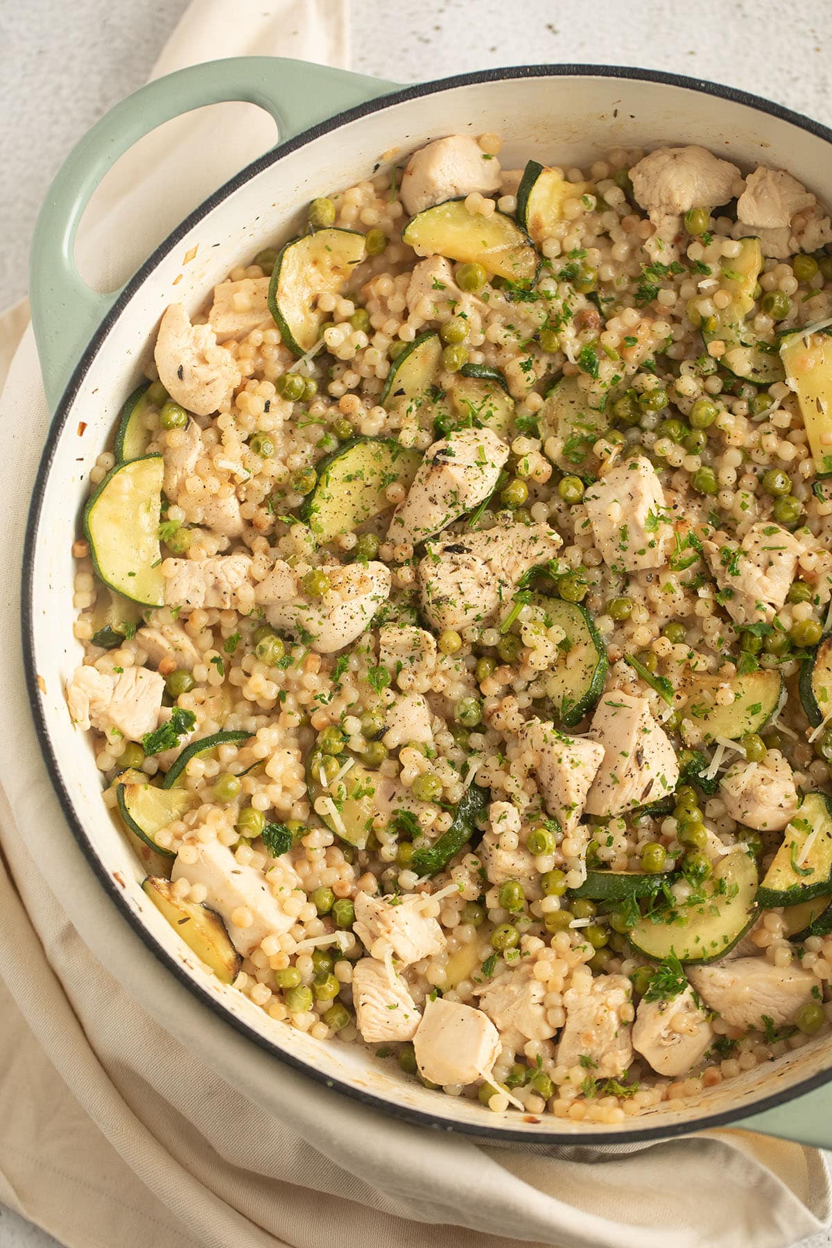 pearl couscous with chicken and zucchini in a large pot.