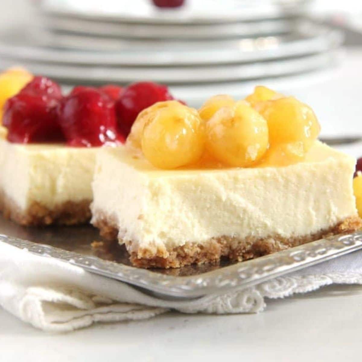 philadelphia cream cheese cherry cheesecake bars on a platter.