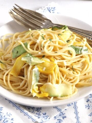 goat cheese spaghetti with zucchini on a plate with fork