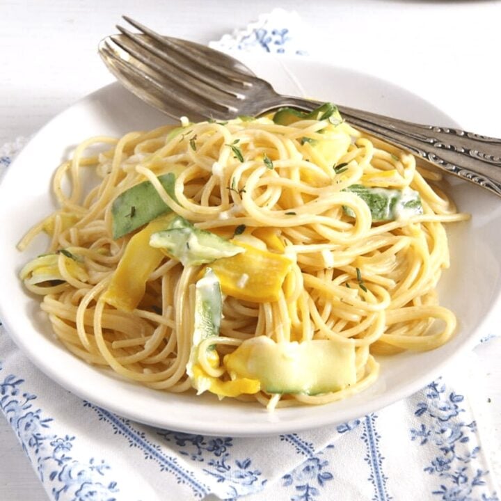 goat cheese spaghetti with zucchini on a plate with fork