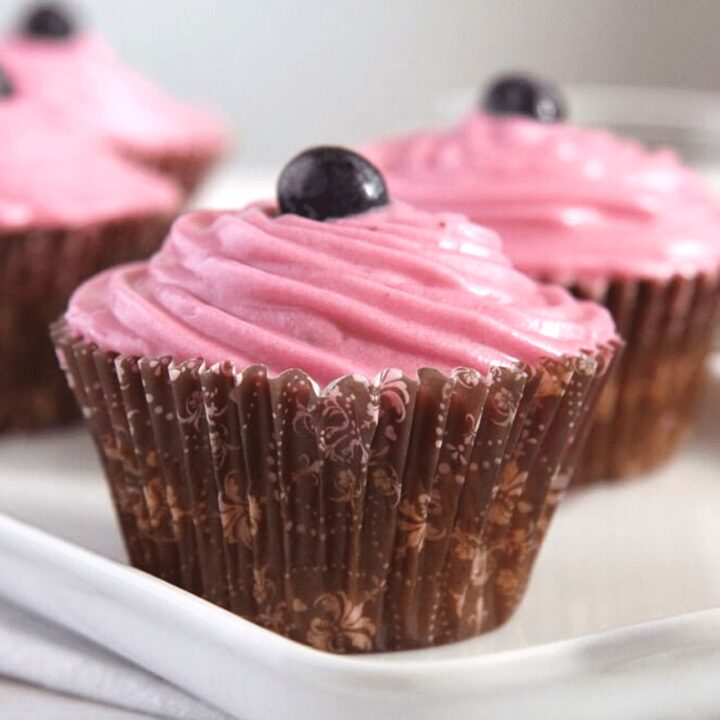 carrot muffins with blueberry frosting close up