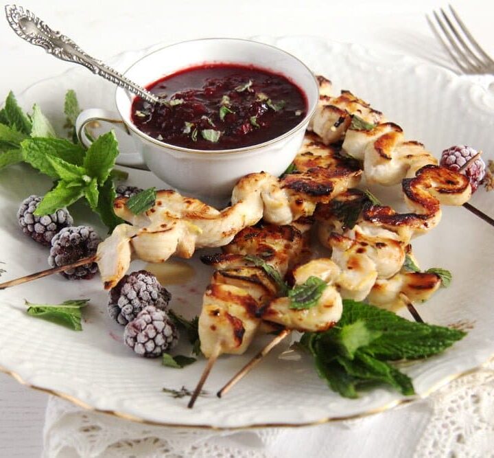 blackberry chicken on a plate decorated with fresh mint