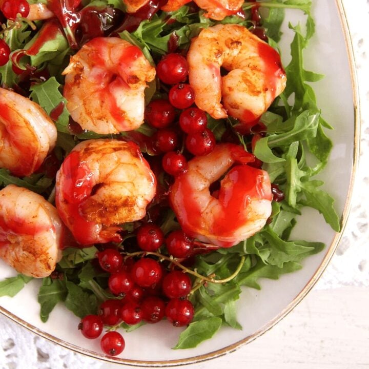 prawn salad with red currant sauce on arugula