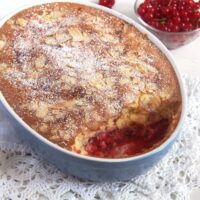 red currant dessert with dough topping in a blue baking dish