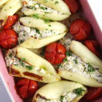 cheese stuffed pepper with tomatoes in a baking dish