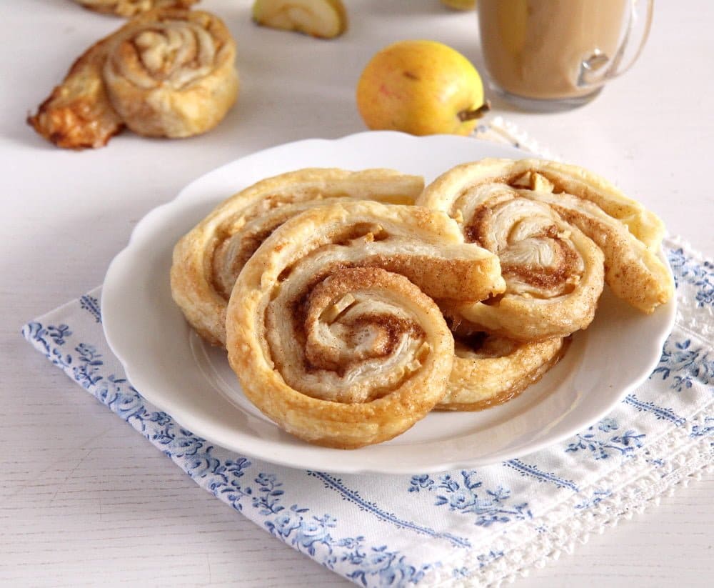 apple pastries with cinnamon on a small white plate