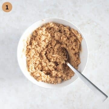 mixing crushed crackers with butter to make a crust for a cheesecake.
