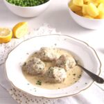 pin image meatballs in caper sauce with peas and potatoes.