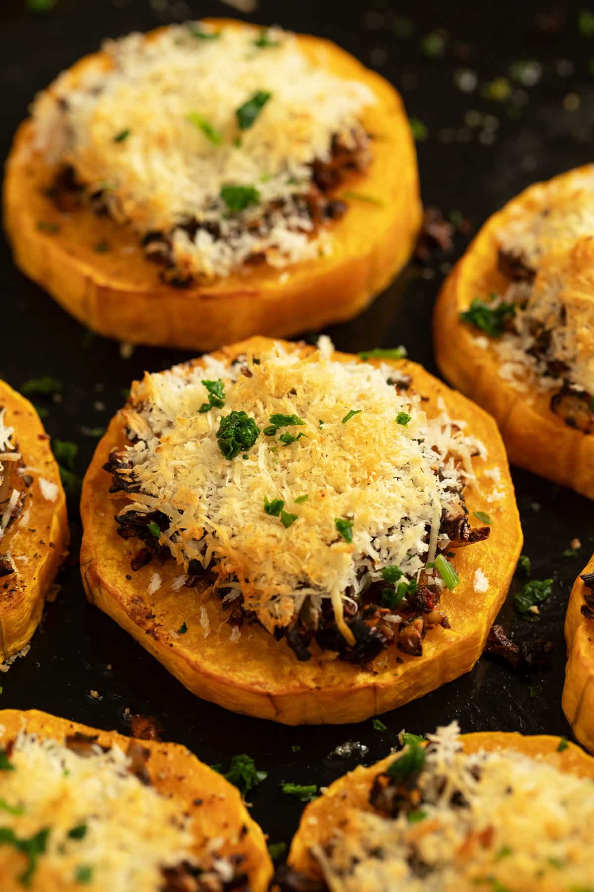 golden baked butternut squash roiunds topped with panko and cheese.