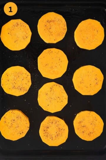 unbaked butternut squash slices sprinkled with salt and pepper on a baking dish.