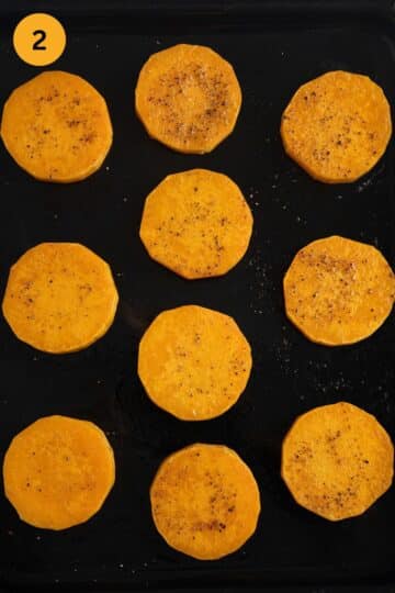 half-baked butternut squash rounds on a baking sheet.