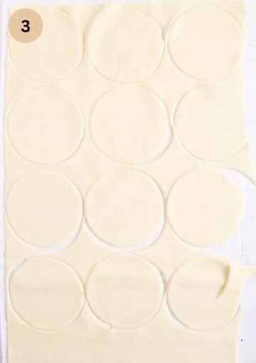 cutting dough circles to make pumpkin filled pasties.