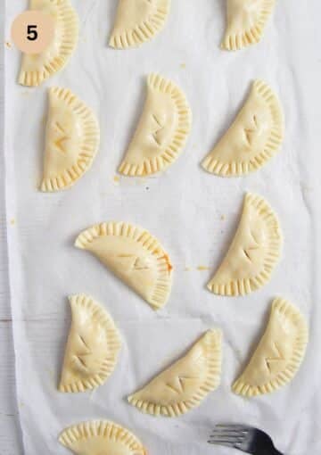 unbaked harry potter pumpkin pasties with the lightning cut on top.