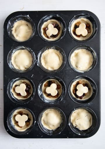 unbaked mincemeat tarts in a muffin tin.