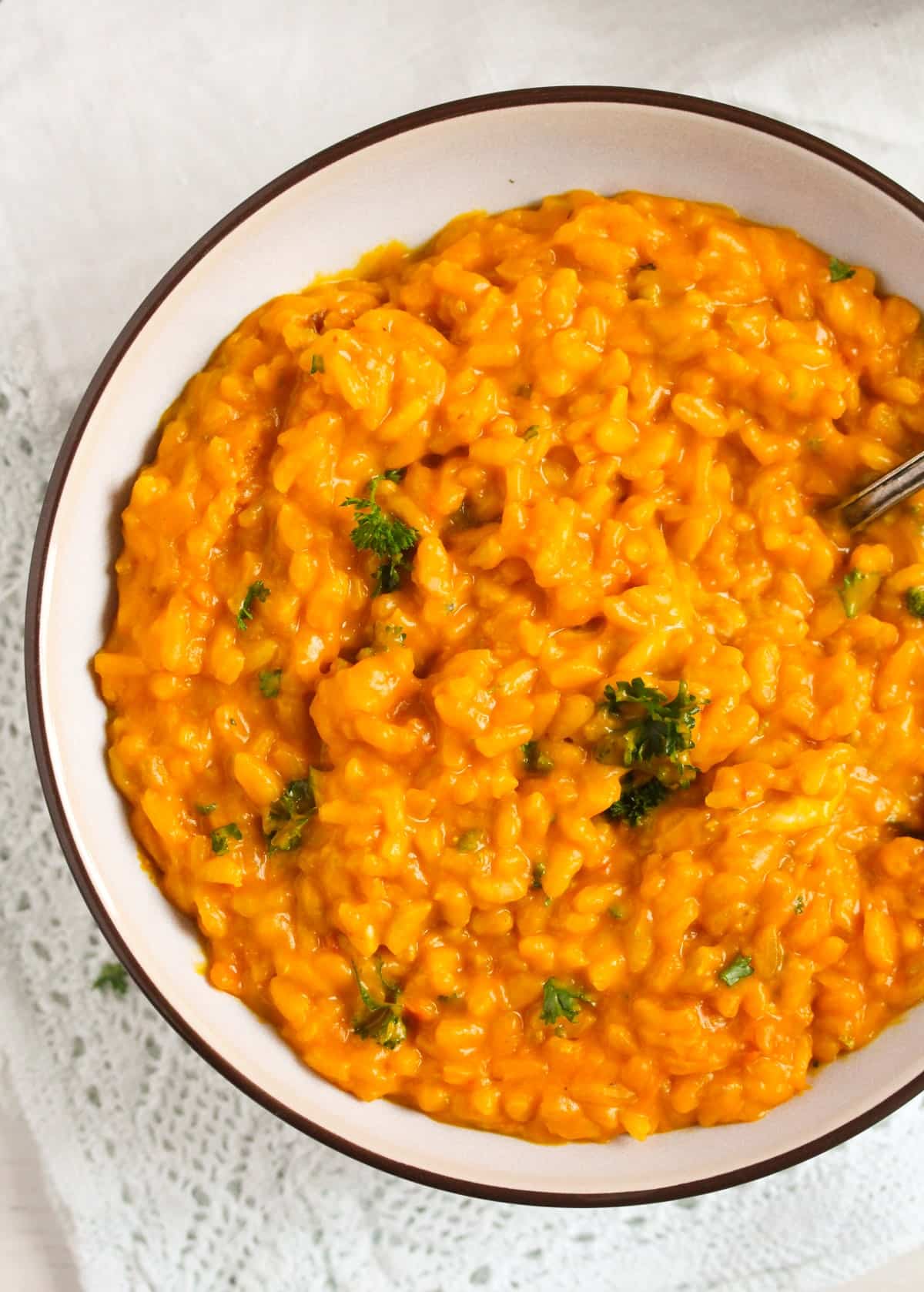 overhead view of creamy risotto with pumpkin and gorgonzola in a bowl.