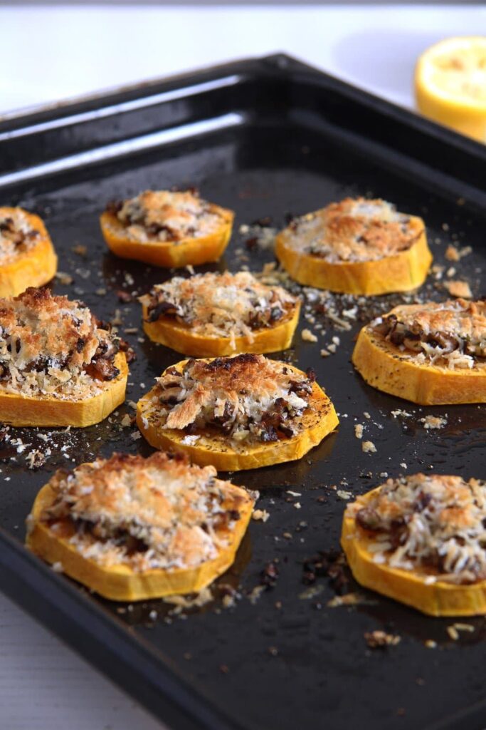 round pieces of squash on a baking tray