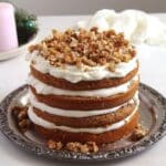 four layered walnut cake with quark filling and caramelized walnut topping.