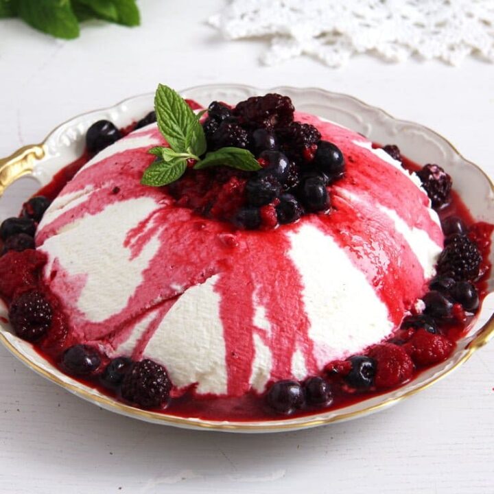yogurt dessert topped with berry sauce and mint