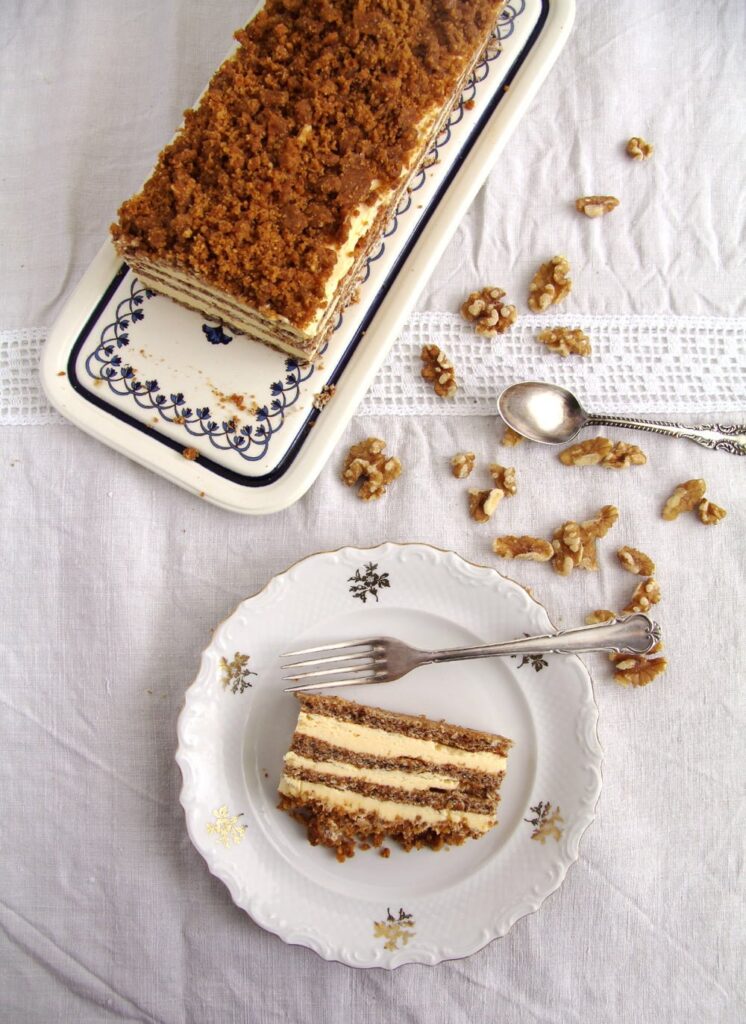 caramel nut cake with buttercream on a plate