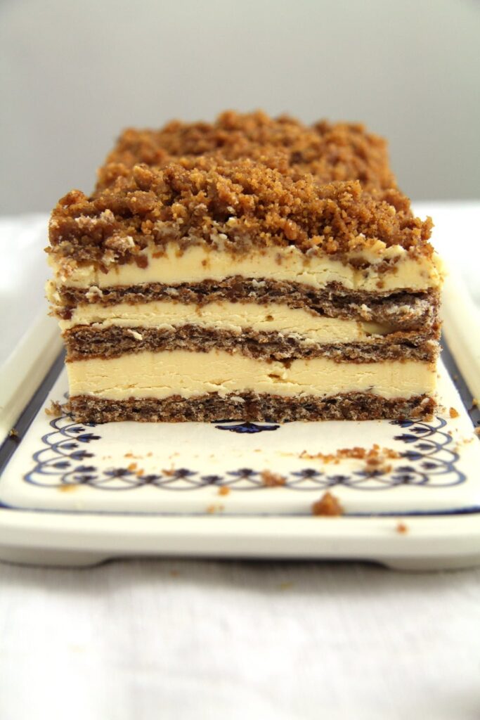 layered cake with caramelized walnuts on a rectangular platter