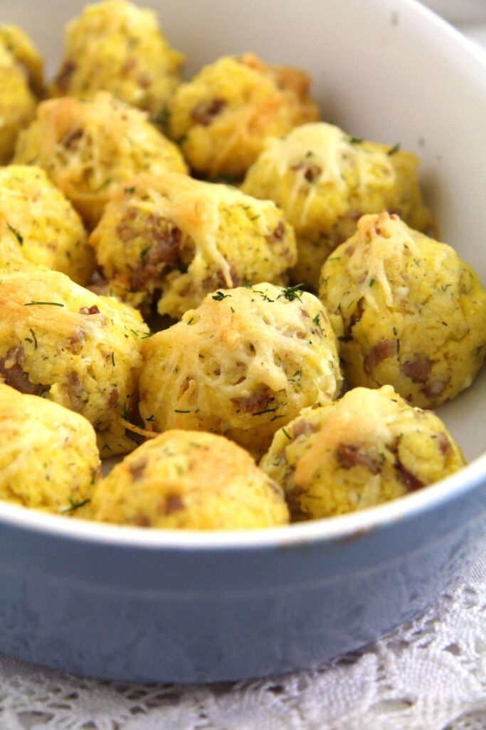 baked polenta cheese balls in a casserole dish close up