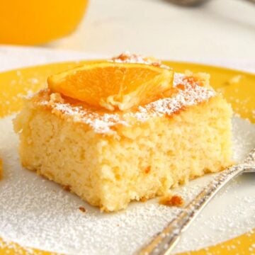 cornmeal cake with orange juice in the back.