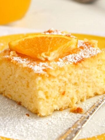 cornmeal cake with orange juice in the back.