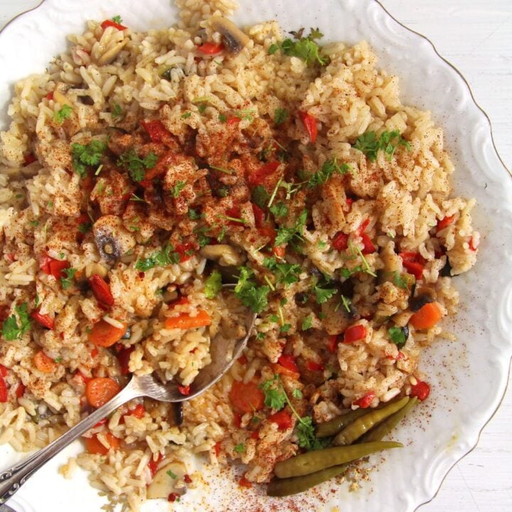 vegan romanian rice served with a silver spoon