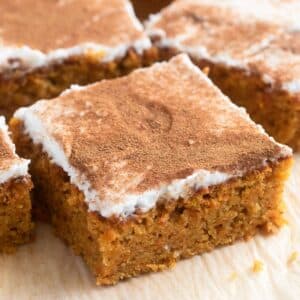spelt flour carrot cake pieces frosted with coconut cream and cinnamon.