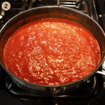 tomato sauce simmering in a pot.