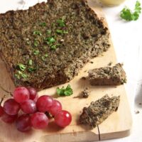 romanian easter drob served with grapes on a wooden board