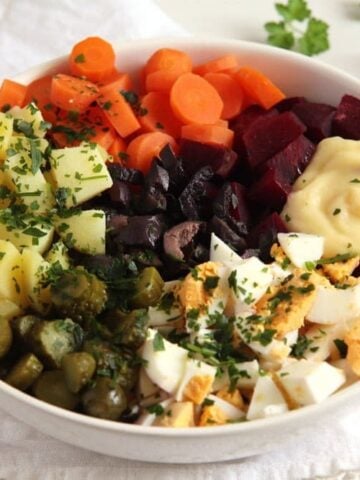 salad russe with carrots, potatoes, gherkins, eggs, beets and mayo