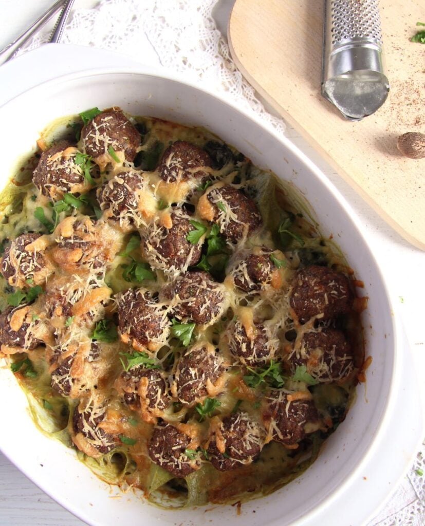 white casserole dish with meatballs and cheese
