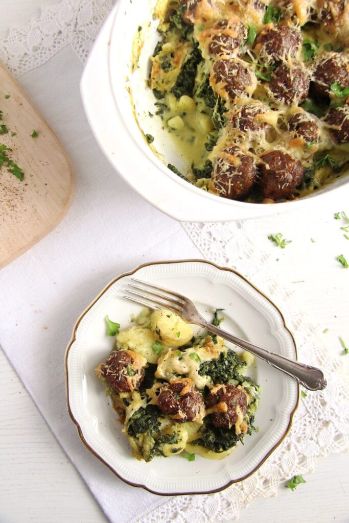 plate with potatoes and meatballs baked in the oven