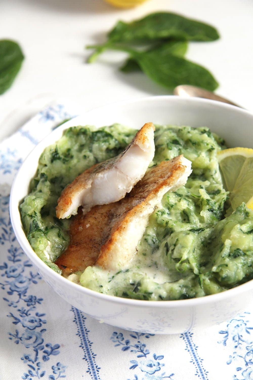 spinach mashed potatoes with fish in a bowl