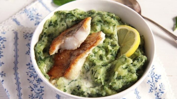 spinach and potato mash in a small bowl with fish.
