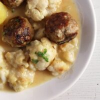 close up turkey meatballs and cauliflower pieces with potatoes