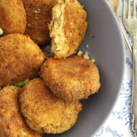 baked cauliflower potato patties in a gray bowl