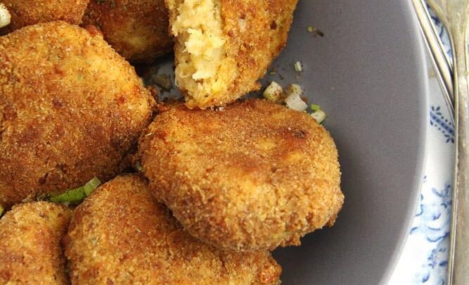 baked cauliflower potato patties in a gray bowl