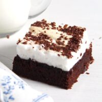 one brownie topped with grated dark chocolate and egg whites.