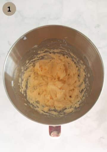 mixing butter and egg for making cake batter in a bowl.