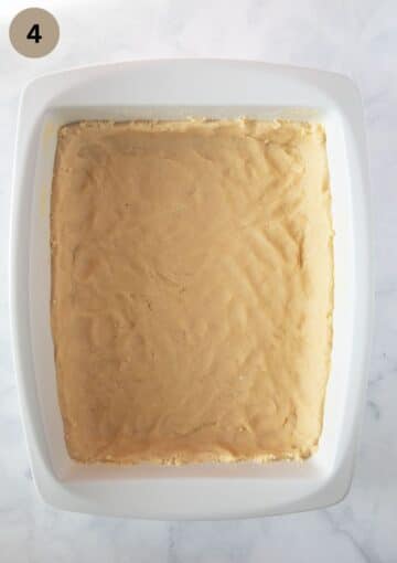 cake dough pressed in a baking dish.